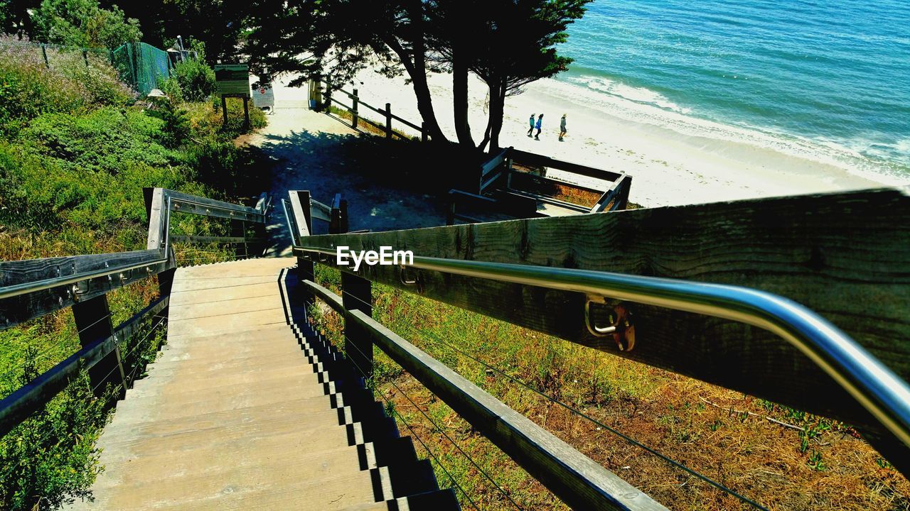 High angle view of steps and staircases leading towards beach during sunny day