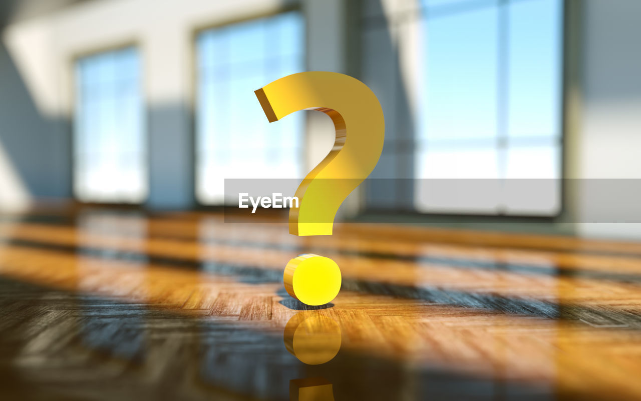 Yellow question mark on table