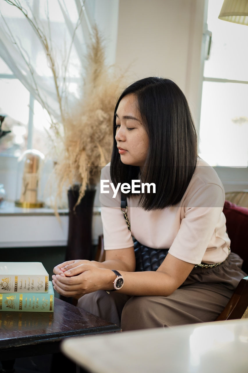 Young woman using mobile phone at home