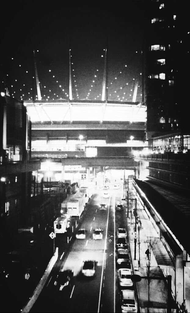 VIEW OF ILLUMINATED CITY AT NIGHT