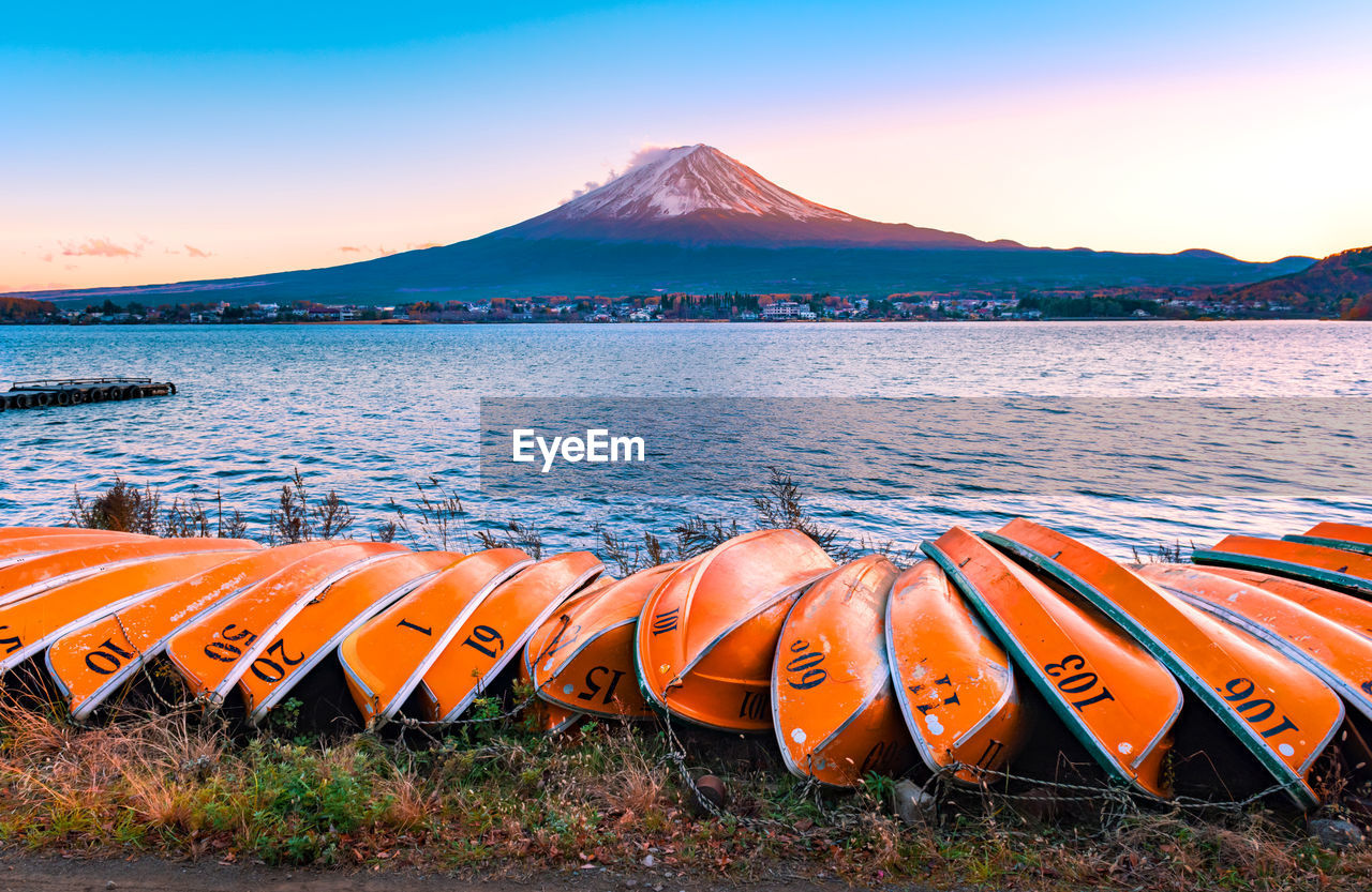 Scenic view of lake and mt fuji against sky during sunset