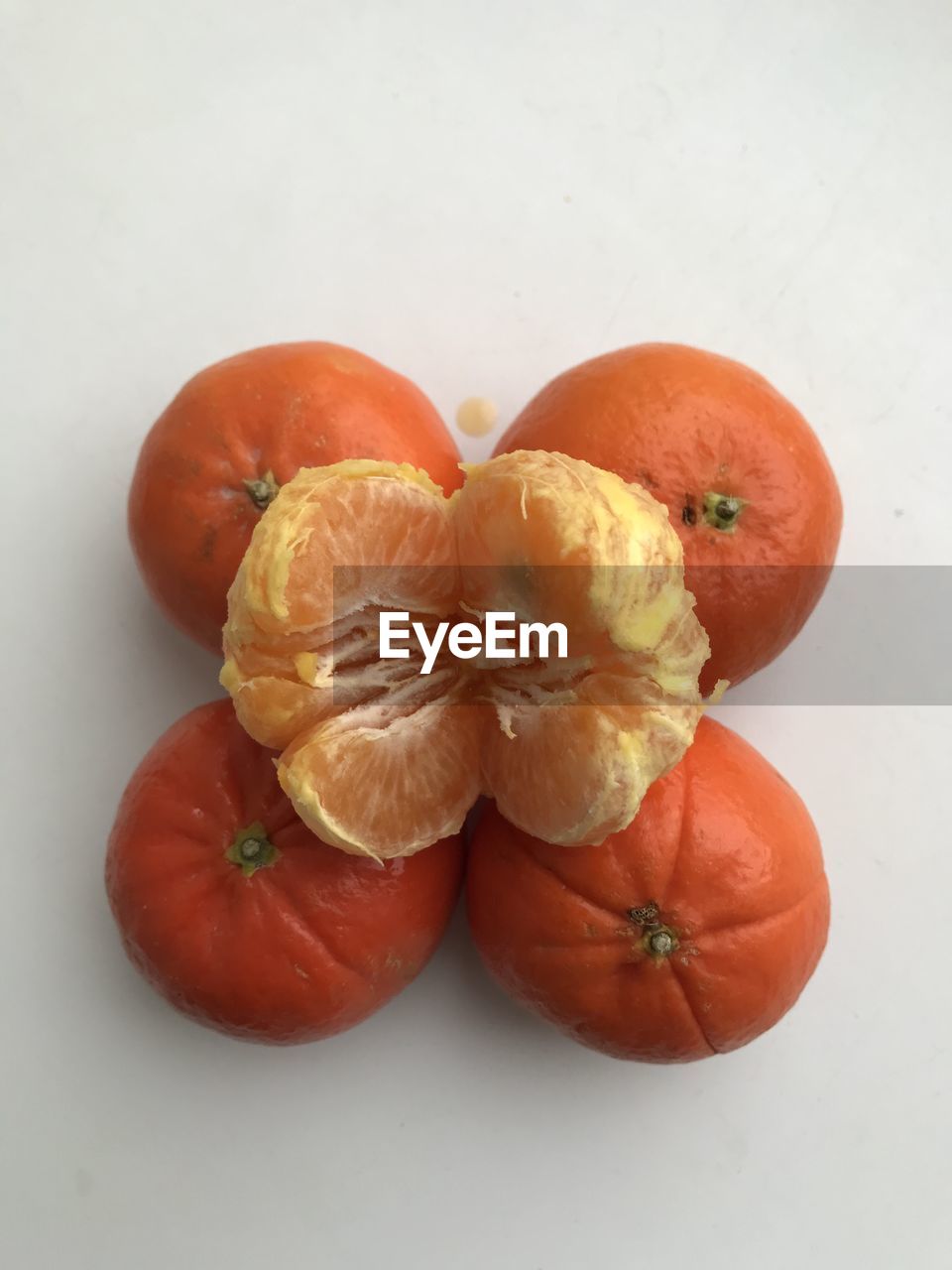 High angle view of orange fruit against white background