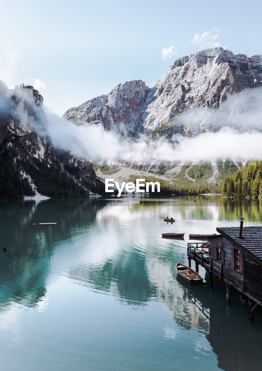 Scenic view of lake and snowcapped mountains against sky