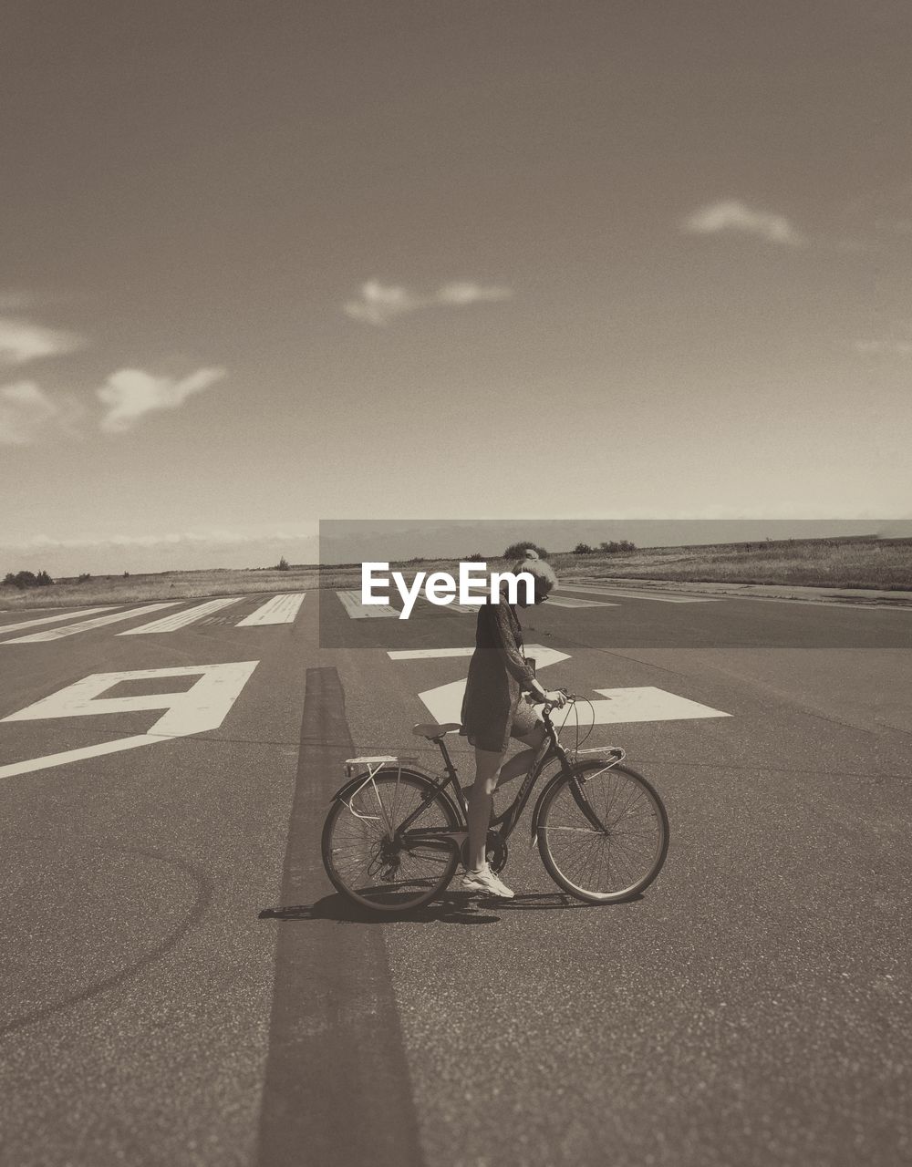 Side view of woman riding bicycle on road