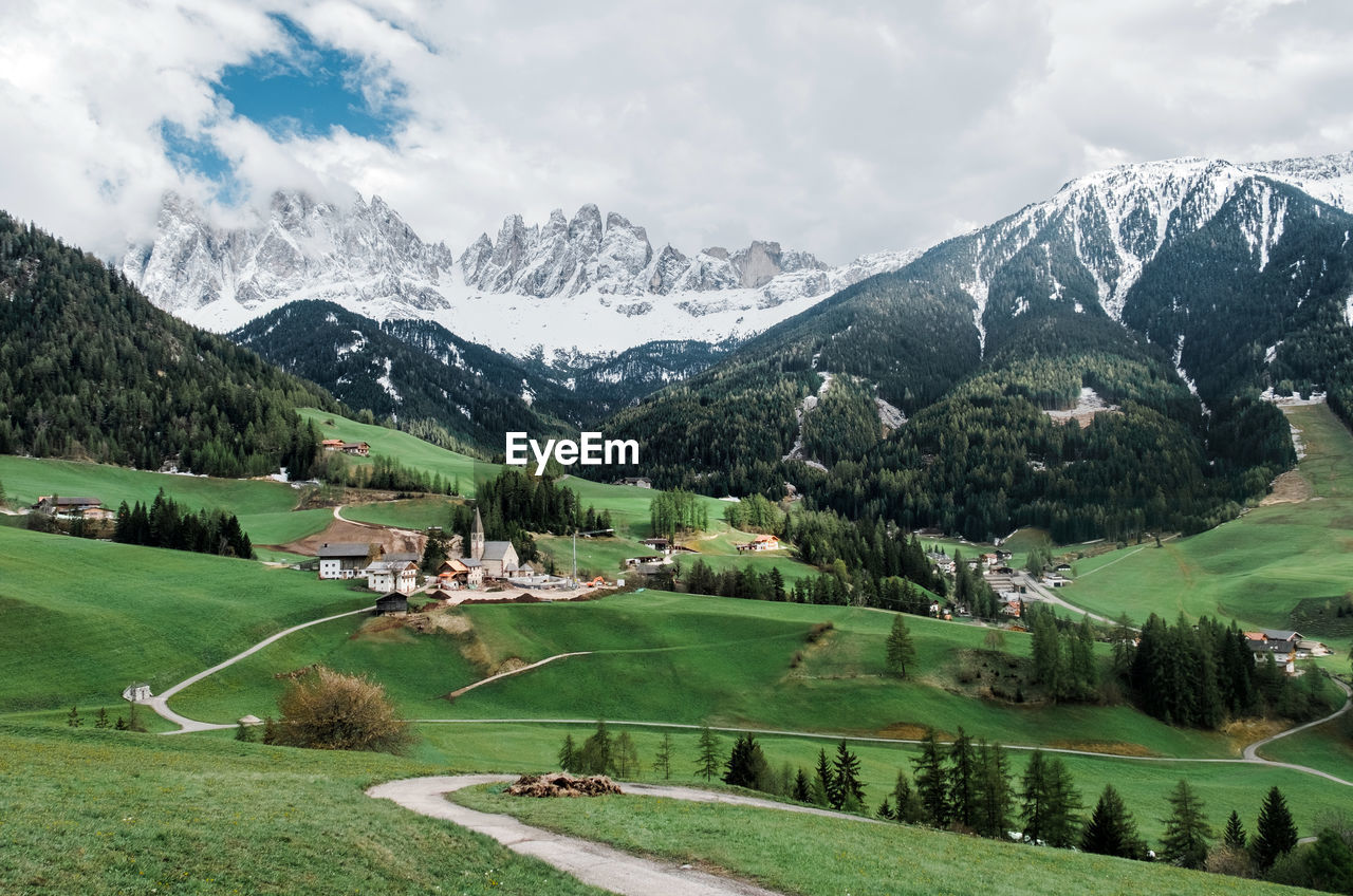 Scenic view of landscape and mountains against sky in dolomiti mountains.
