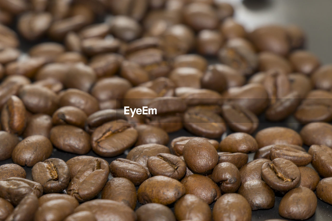 FULL FRAME SHOT OF COFFEE BEANS IN BACKGROUND