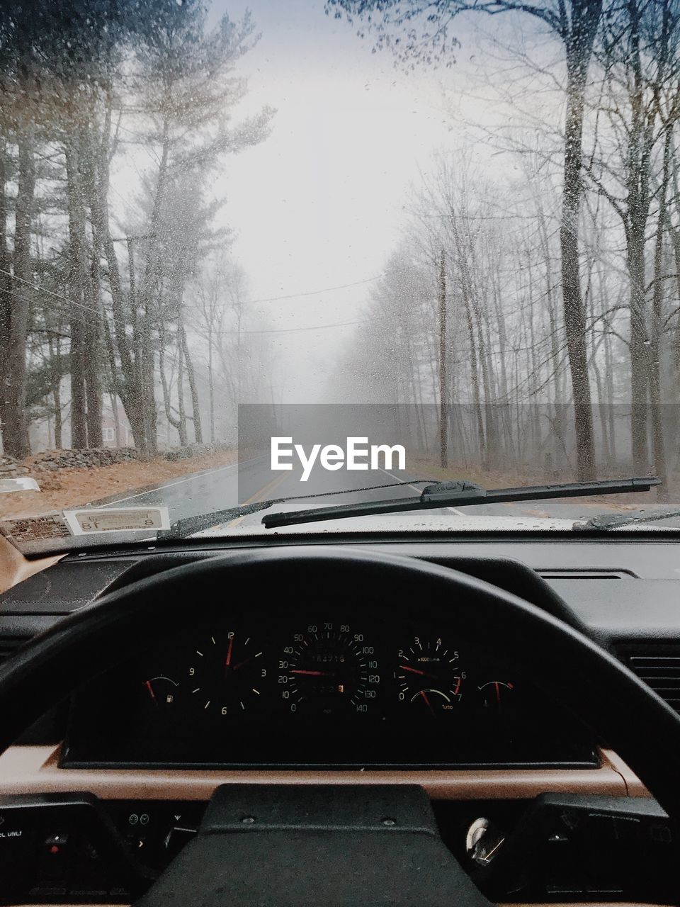 ROAD SEEN THROUGH CAR WINDSHIELD