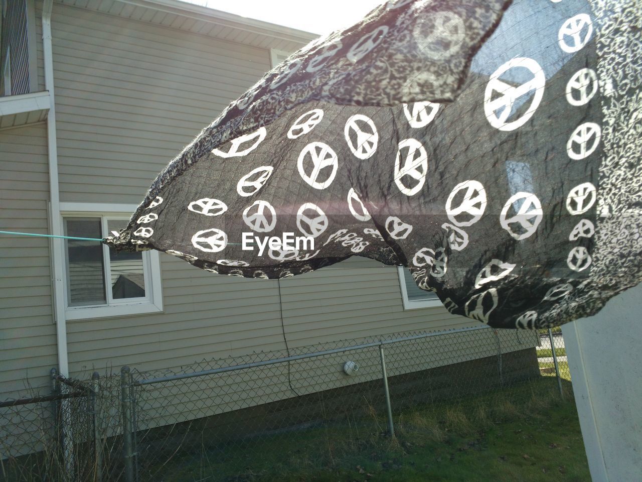 Black scarf waving on clothesline in back yard