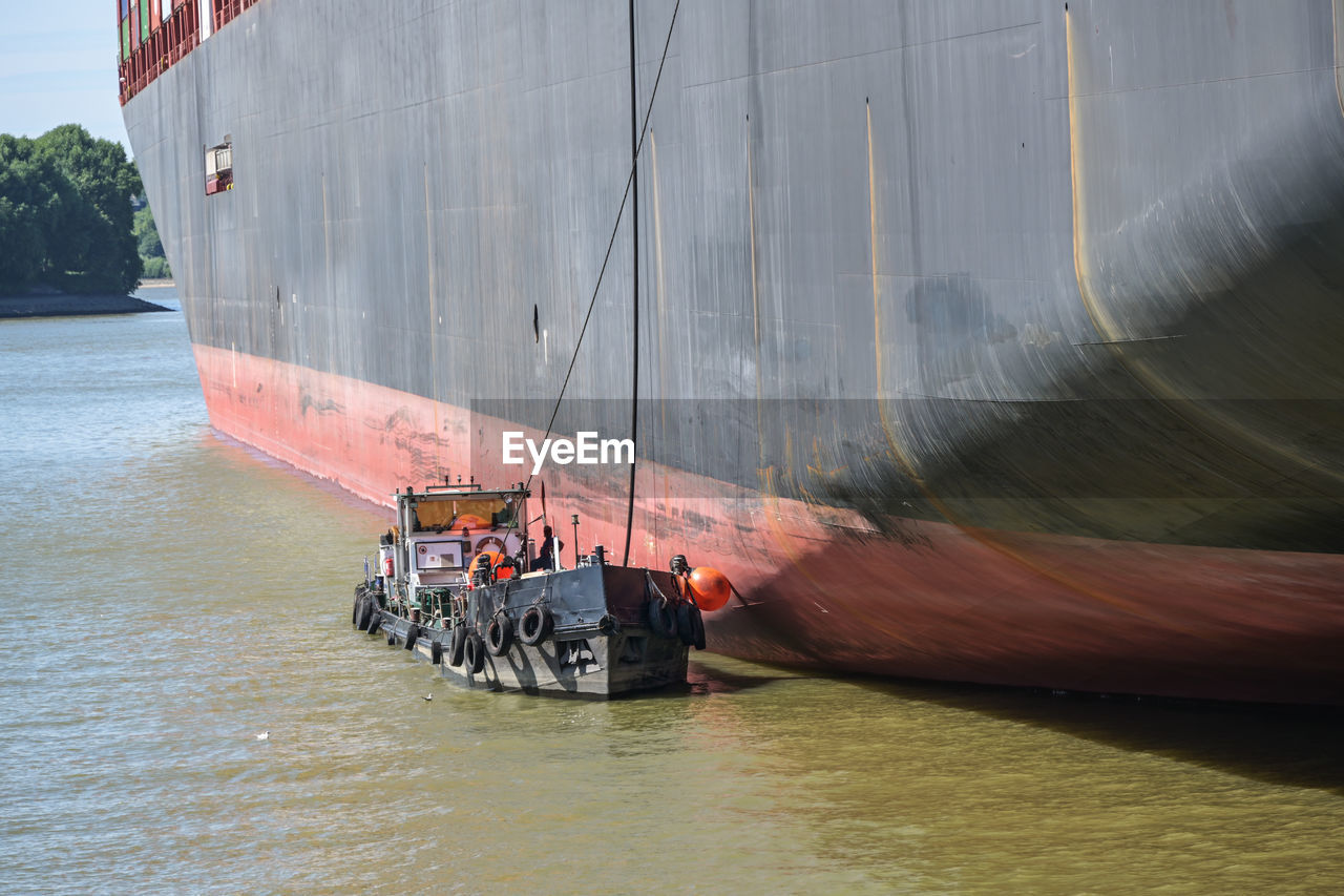 water, nautical vessel, transportation, boat, vehicle, ship, mode of transportation, watercraft, nature, day, waterfront, sea, outdoors, sailboat, freight transportation, architecture, sailing, travel, waterway, men