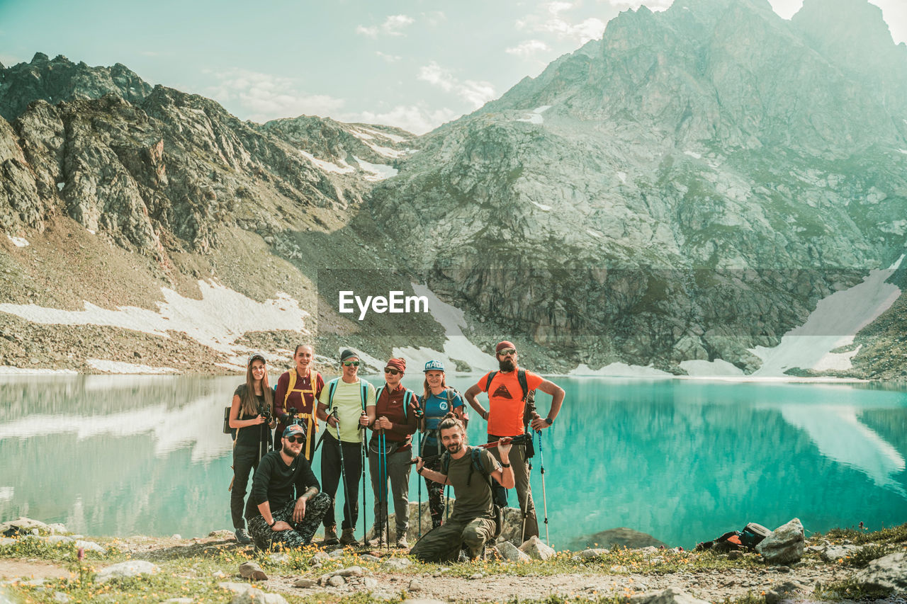 PANORAMIC VIEW OF PEOPLE BY LAKE