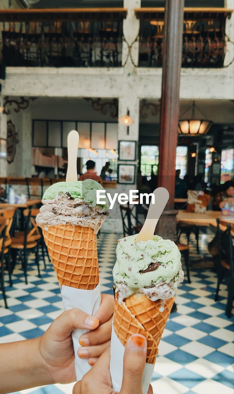 Cropped hands of woman holding ice cream