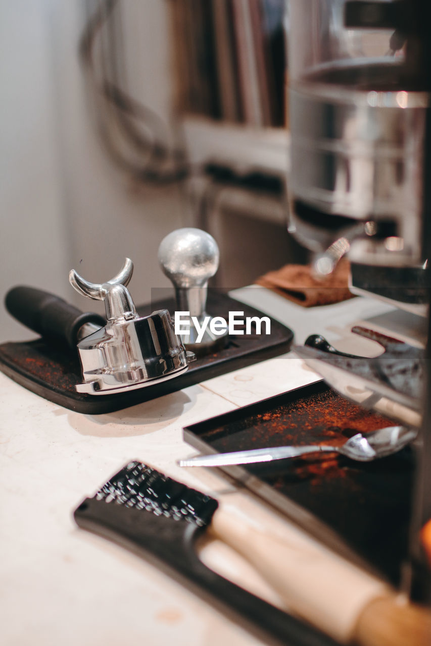 CLOSE-UP OF KITCHEN UTENSILS ON TABLE