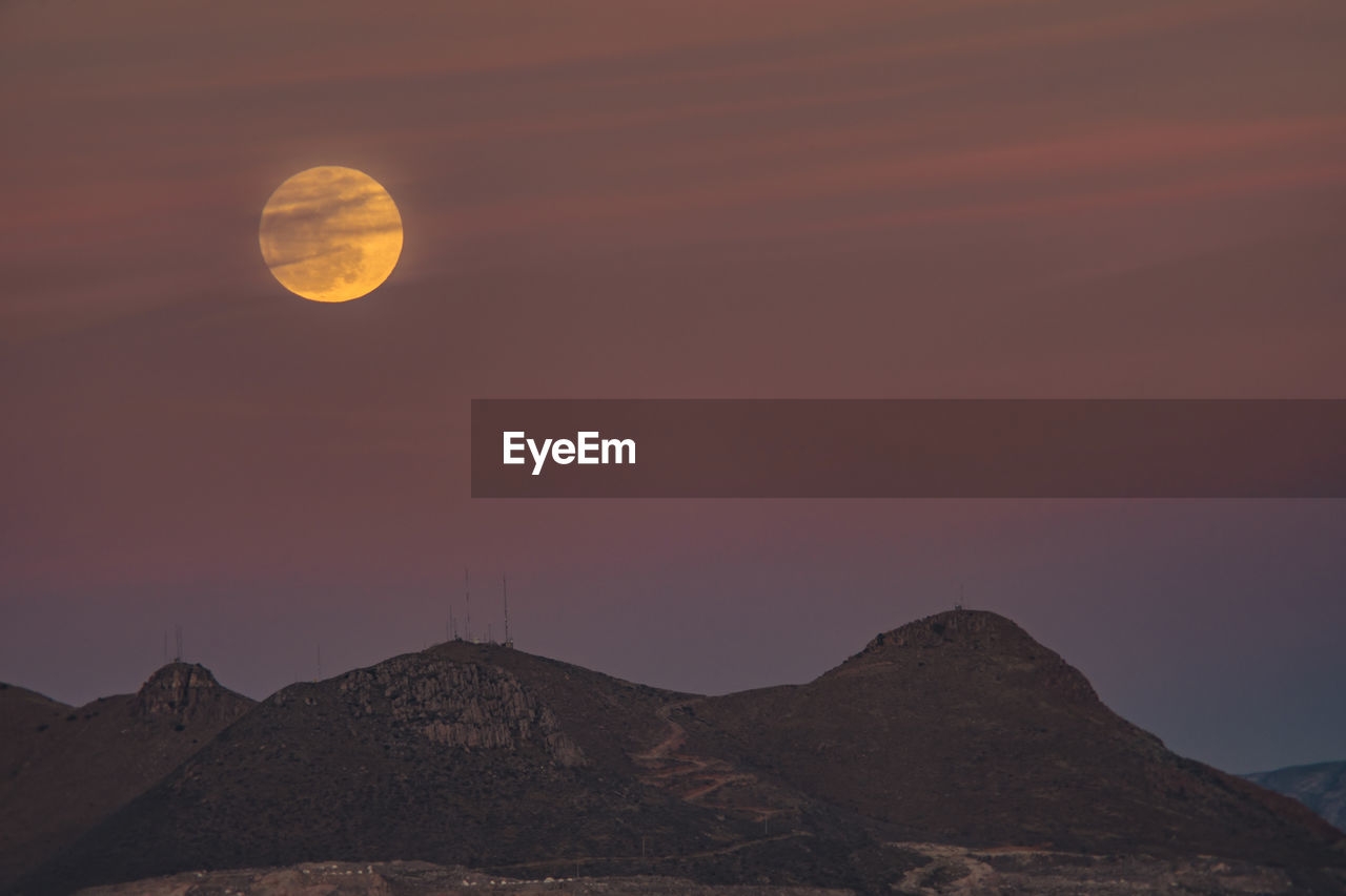 Scenic view of mountains against sky at night