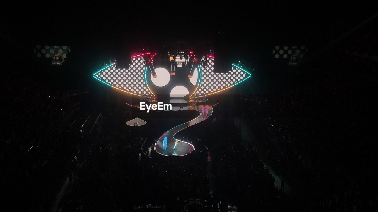 HIGH ANGLE VIEW OF ILLUMINATED LIGHTING EQUIPMENT IN THE DARK