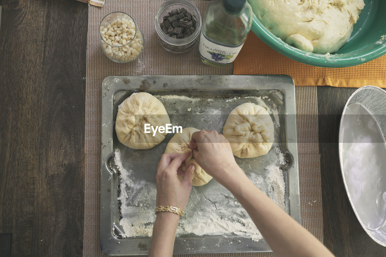 Cropped image of hands kneading dough for challah bread at table