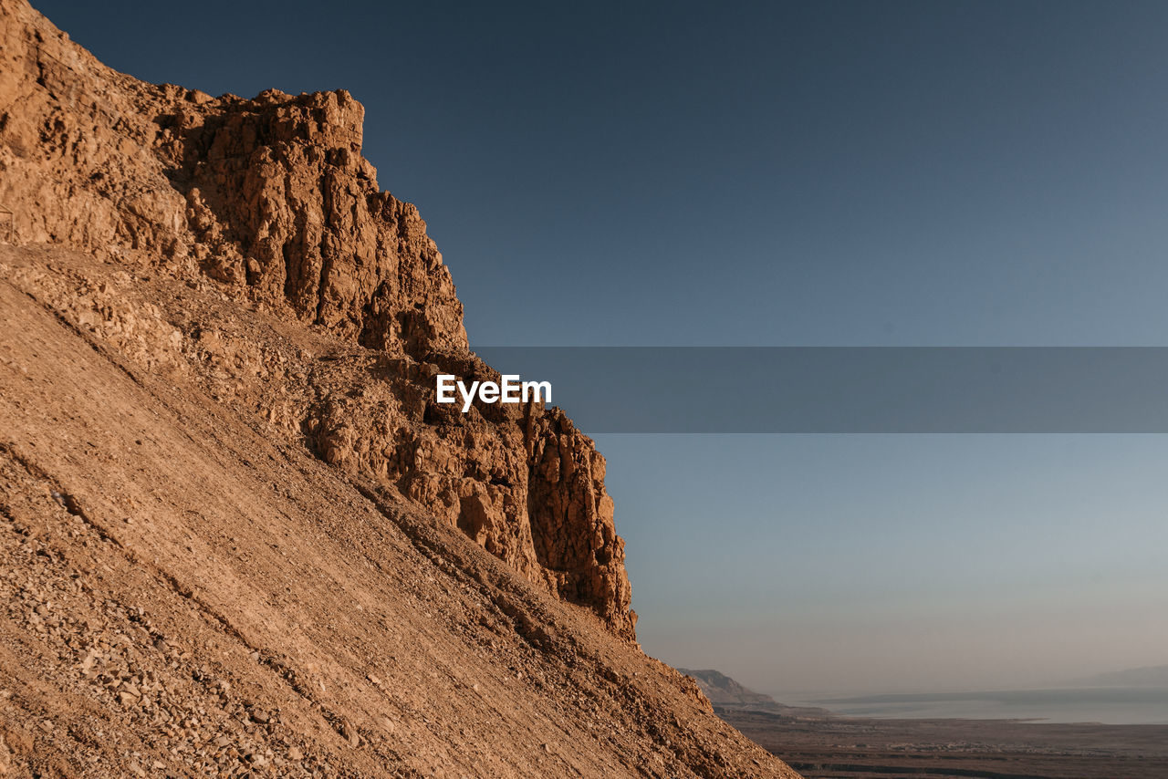 Scenic view of rocky mountains against clear sky