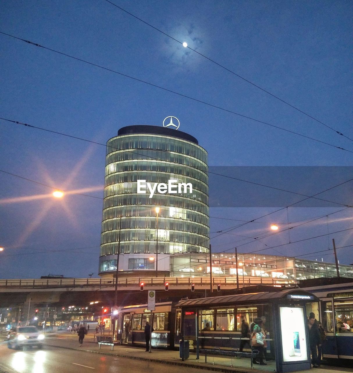 LOW ANGLE VIEW OF ILLUMINATED CITY AT NIGHT