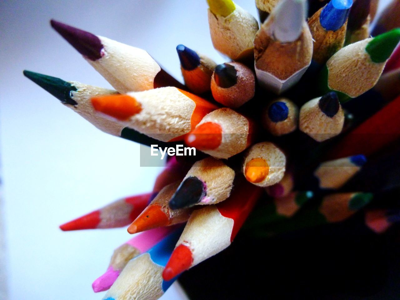 CLOSE-UP OF MULTI COLORED PENCILS ON PAPER