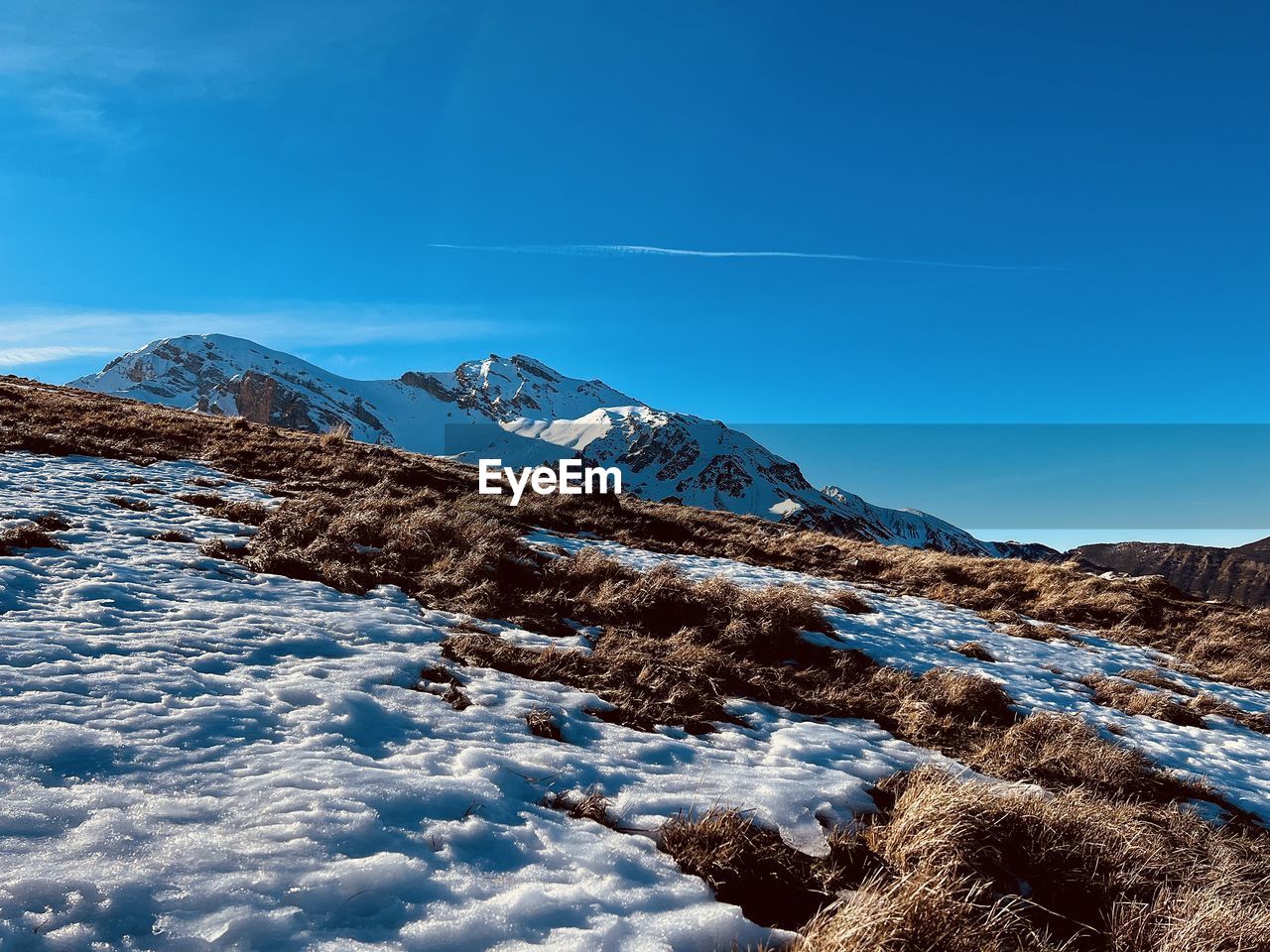 scenic view of snow covered mountains against blue sky