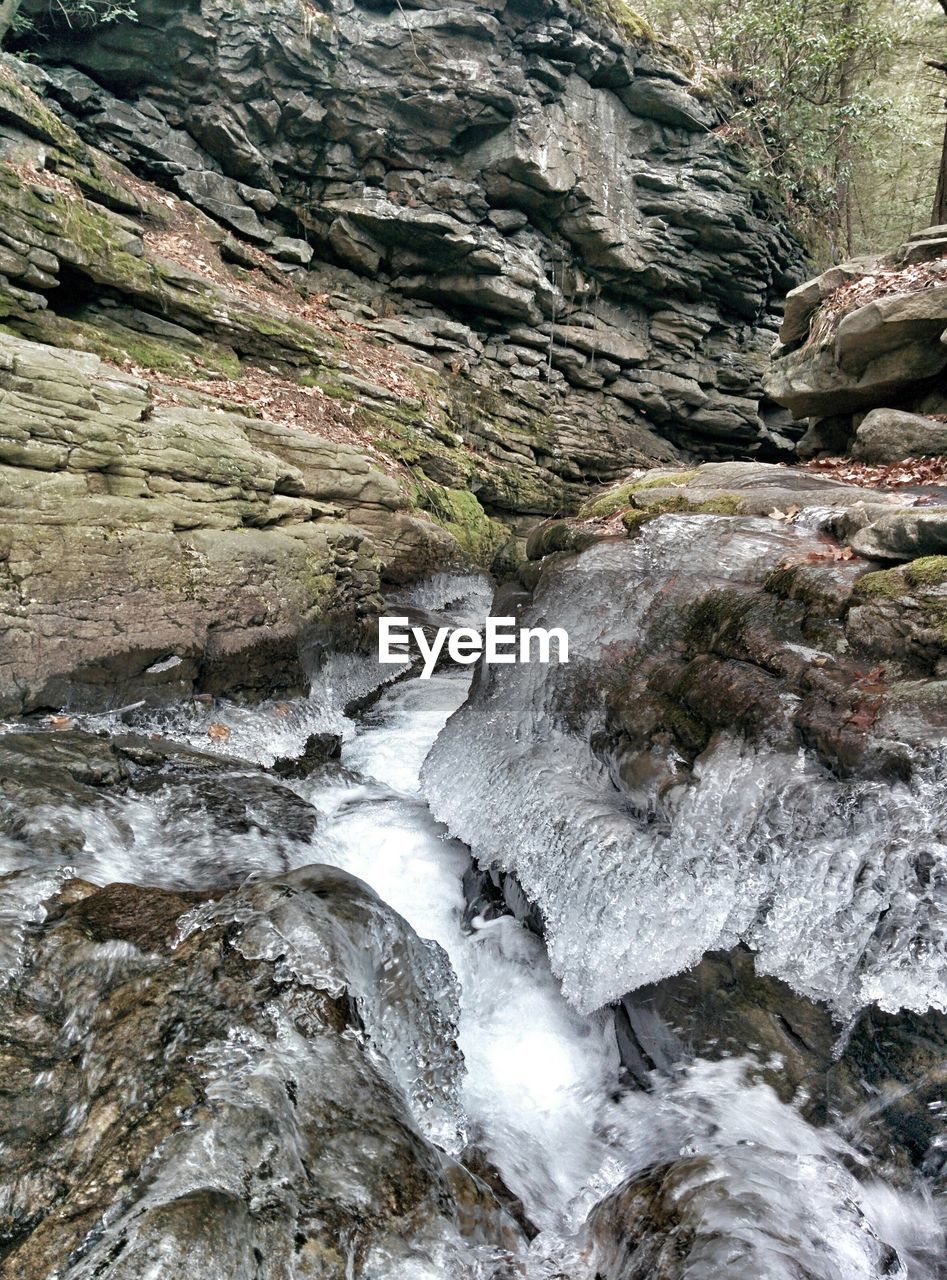 Frozen water and rock formations in forest