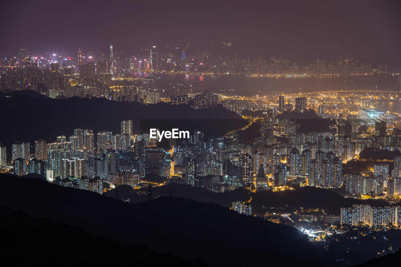 High angle view of illuminated city buildings at night