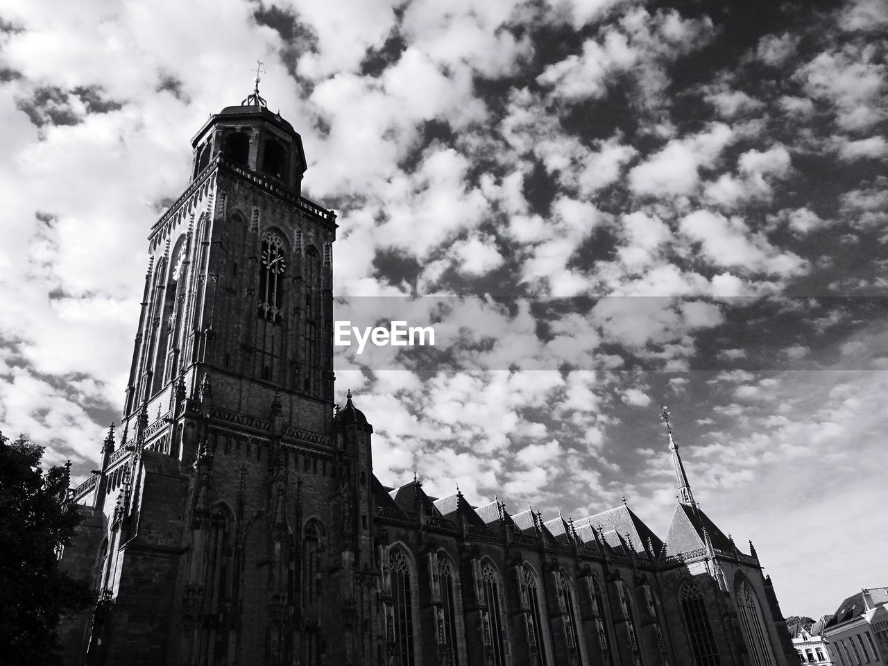 Low angle view of clock tower against cloudy sky