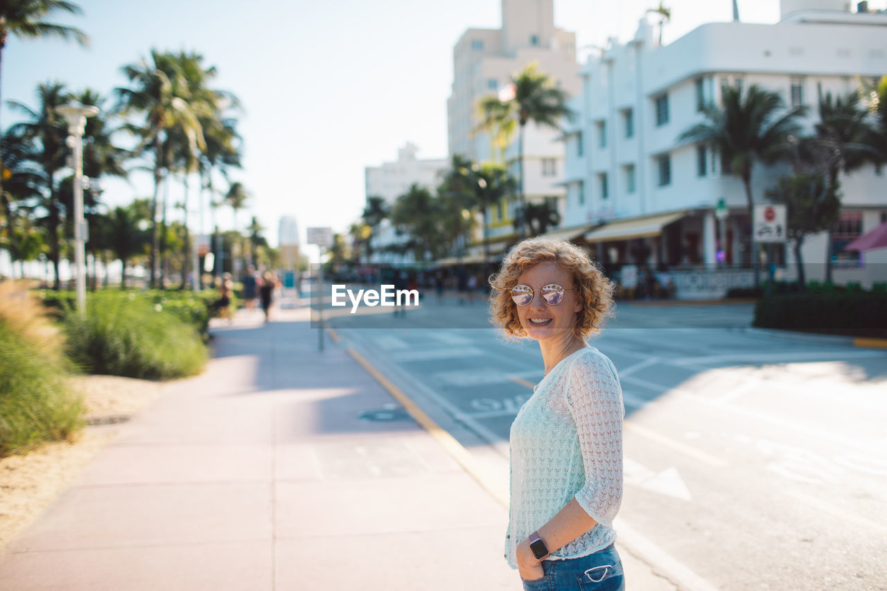 portrait of young woman standing on street