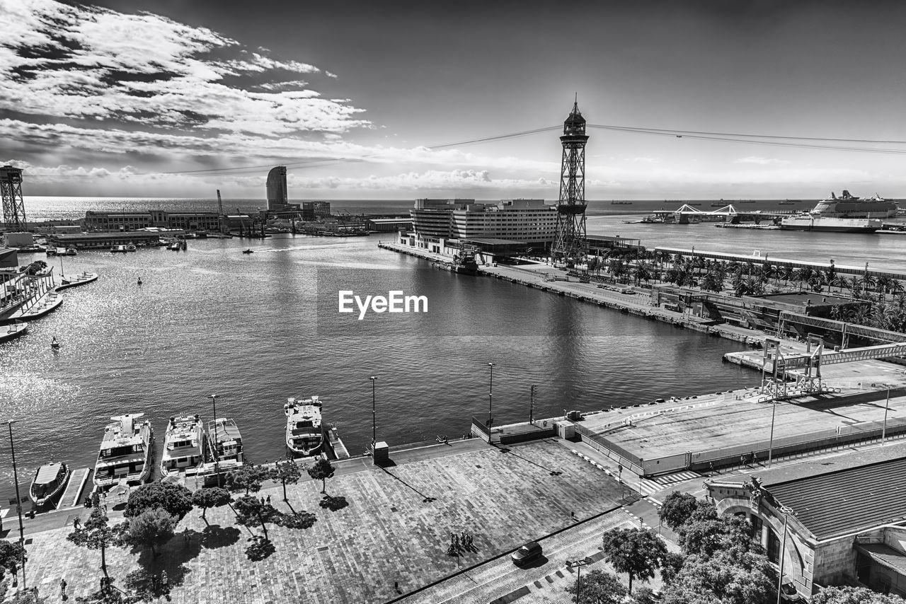 architecture, water, built structure, sky, transportation, nature, building exterior, black and white, city, cityscape, travel destinations, monochrome, monochrome photography, cloud, sea, travel, high angle view, bridge, nautical vessel, outdoors, tourism, no people, building, dock, mode of transportation, urban area, landscape, environment, reflection, harbor, industry, day, tower, aerial photography