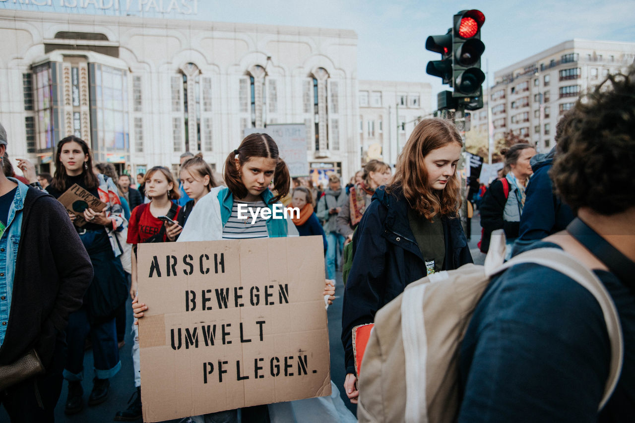 GROUP OF PEOPLE IN FRONT OF CITY