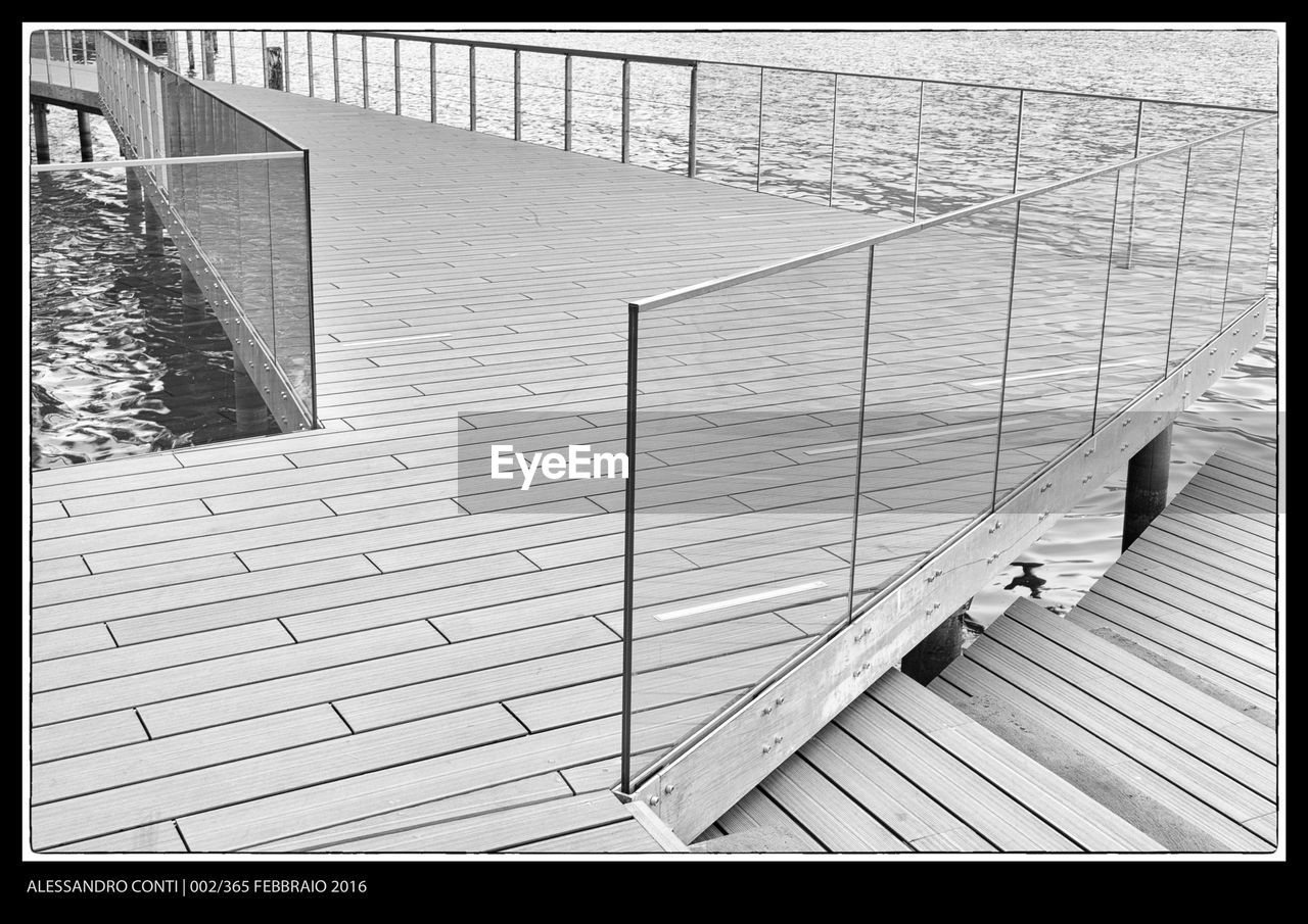 railing, high angle view, steps and staircases, day, steps, real people, outdoors, men, water, hand rail, low section, people