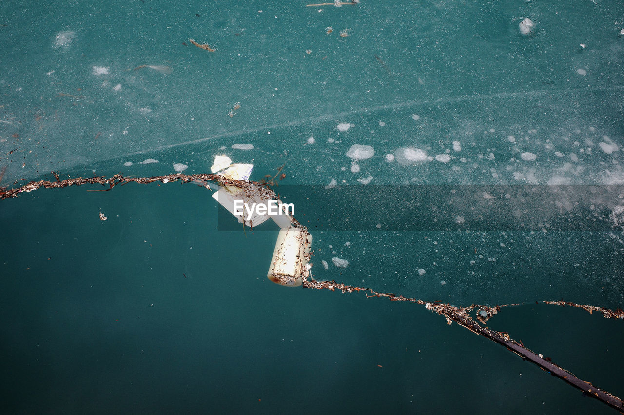 High angle view of debris and garbage on lake