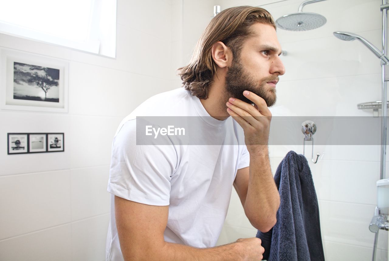 Bearded young man at domestic bathroom