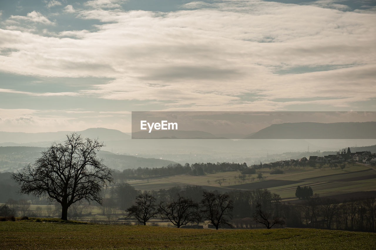 Scenic view of landscape against cloudy sky