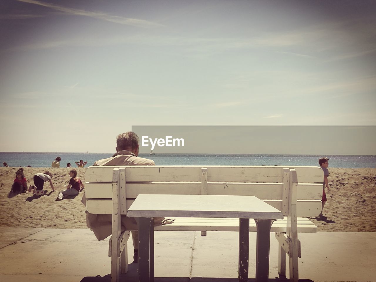 PEOPLE AT BEACH AGAINST CLEAR SKY