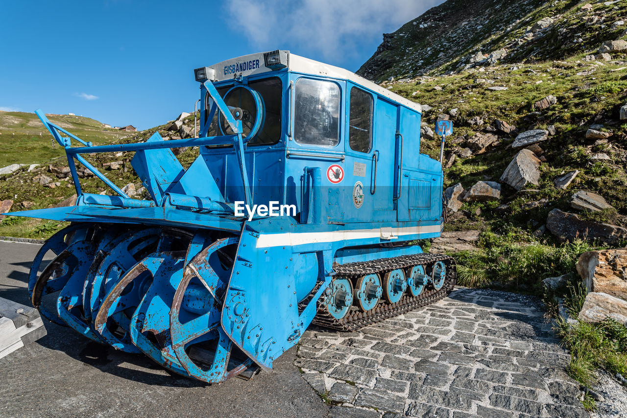 ABANDONED TRAIN ON FIELD AGAINST SKY