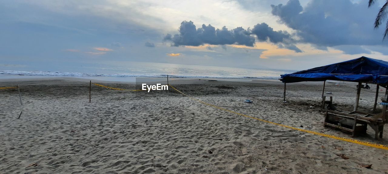 Scenic view of beach against sky during sunset