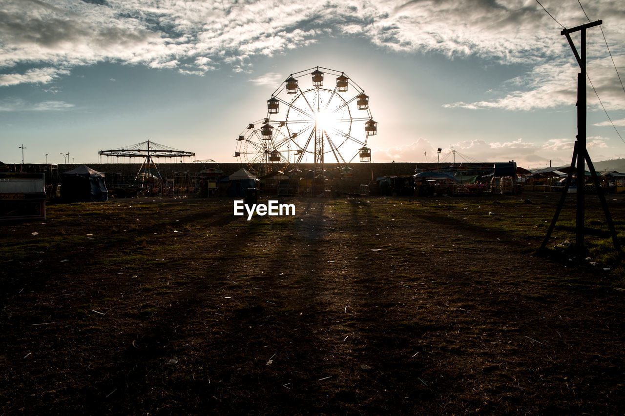 Ferris wheel against sky on sunny day