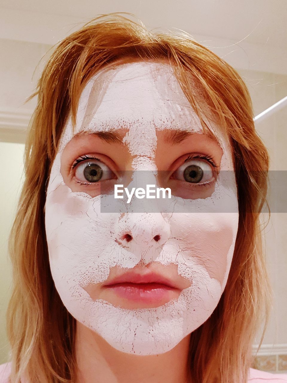 Close-up portrait of young woman with facial mask