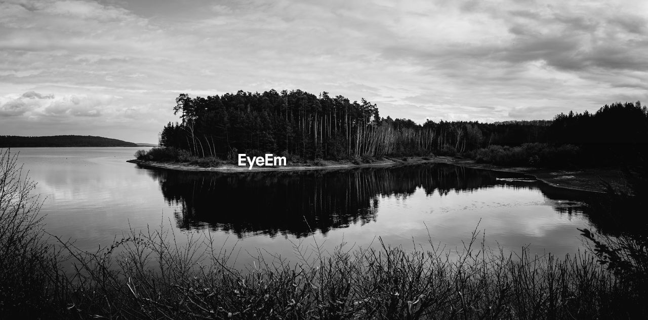 water, reflection, nature, sky, black and white, scenics - nature, tranquility, lake, beauty in nature, monochrome photography, cloud, tranquil scene, plant, monochrome, tree, no people, non-urban scene, environment, landscape, land, darkness, morning, outdoors, mountain, travel destinations, forest, idyllic, day, beach