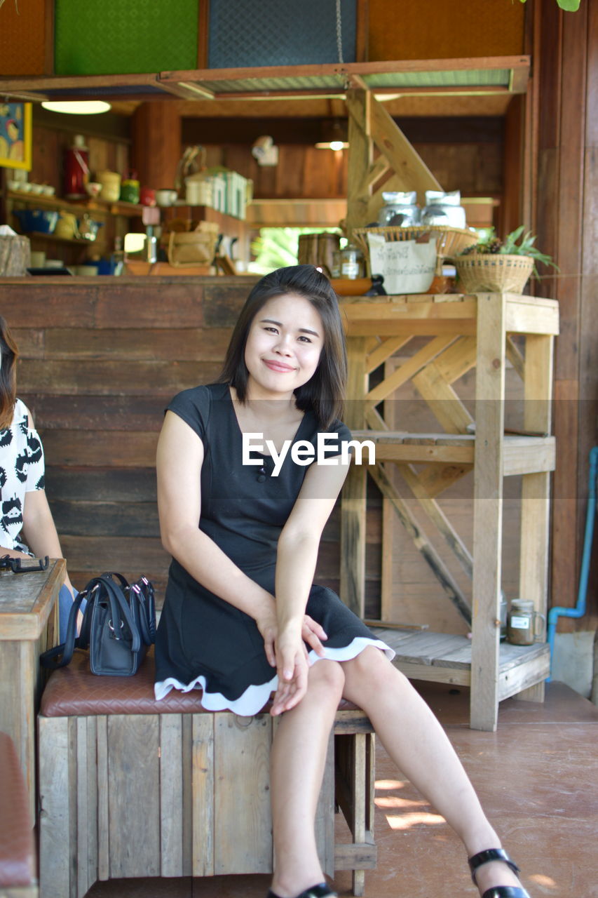 Portrait of young woman sitting at cafe