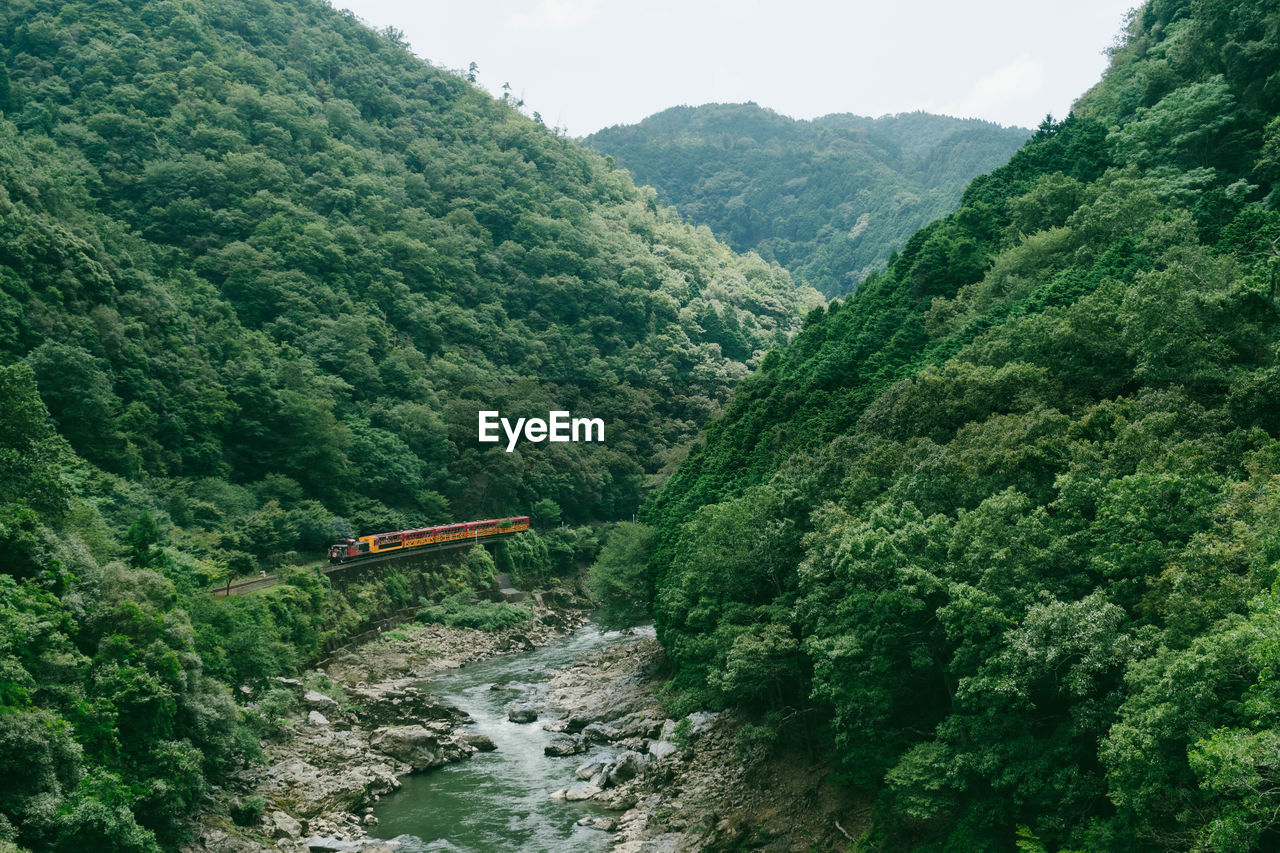 Romantic train along hozukyo river, arashiyama, kyoto prefecture, japan