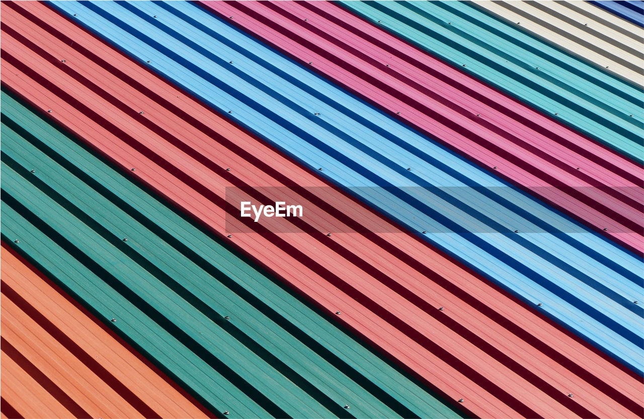 Full frame shot of multi colored metal sheet of roof pattern
