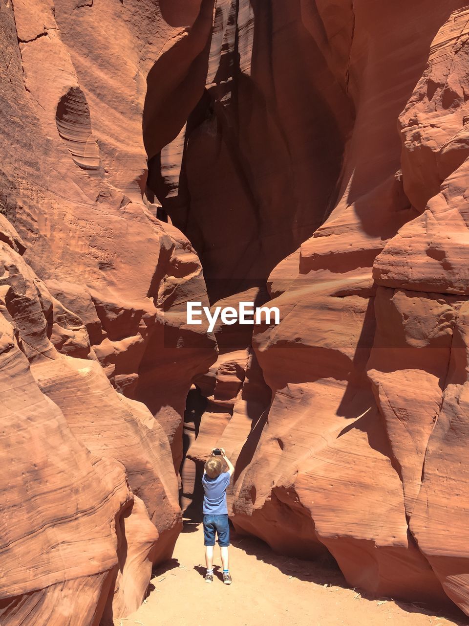 Child photographing rock formation