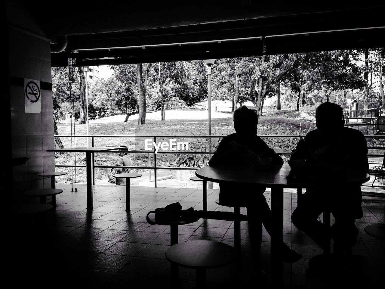 Silhouette people sitting on chairs