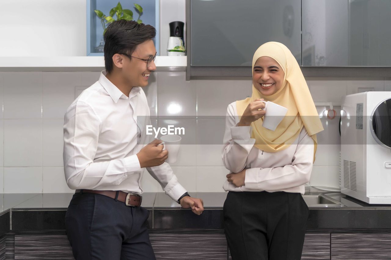 YOUNG COUPLE STANDING ON THE FLOOR