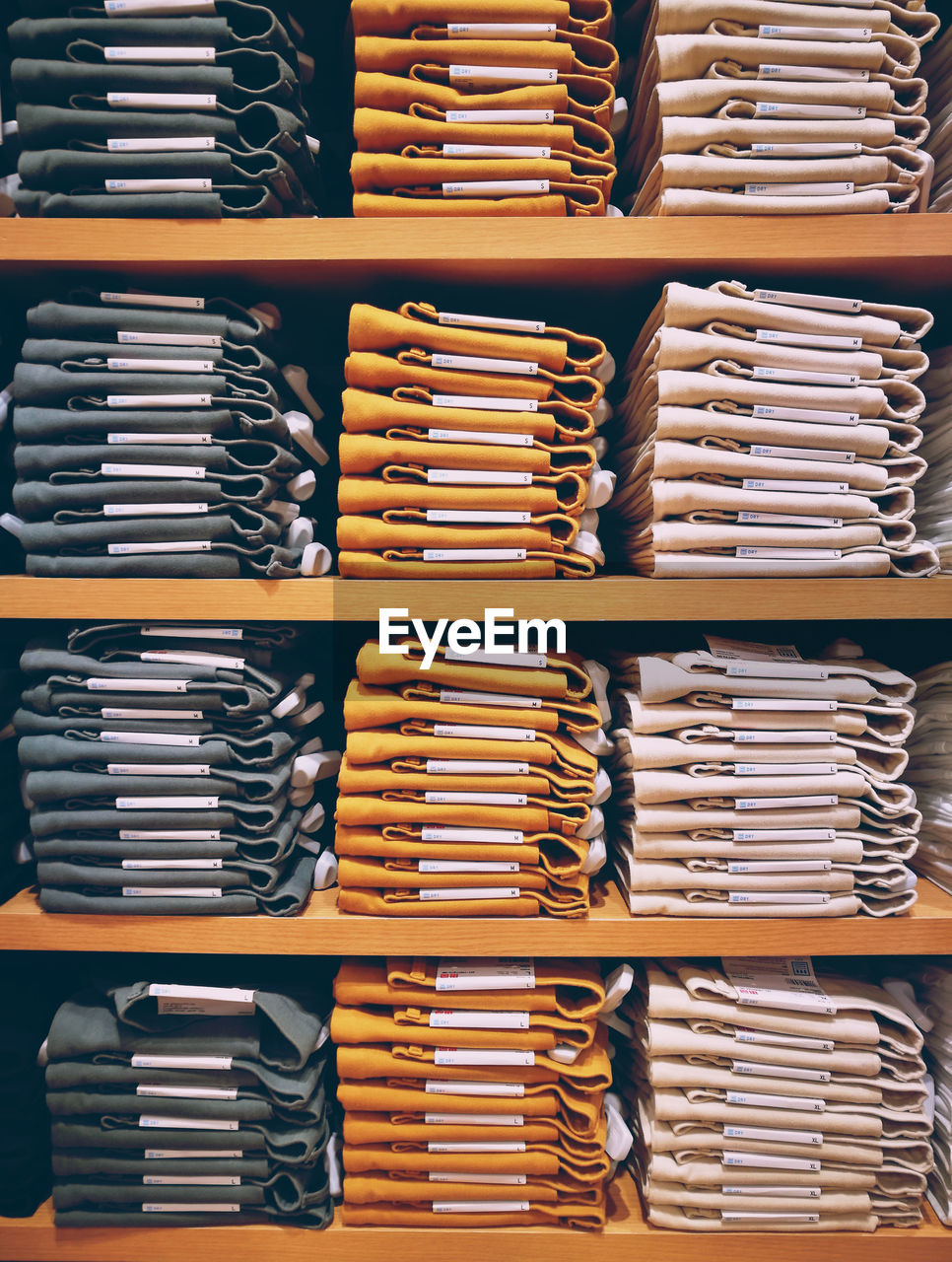 Full frame shot of folded clothes in shelf at store for sale