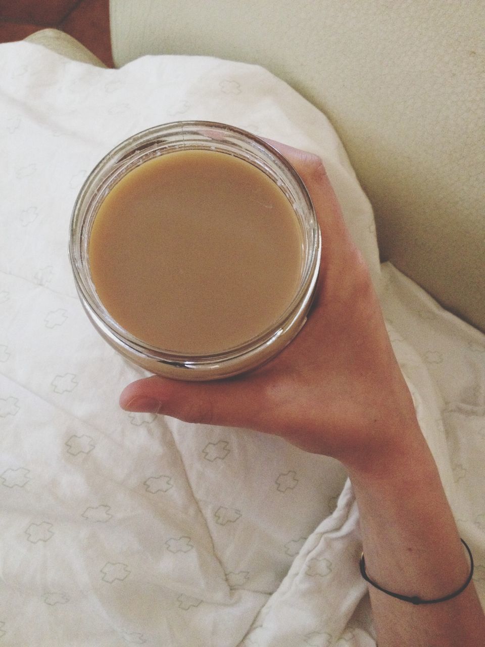 Person hand holding cup of tea
