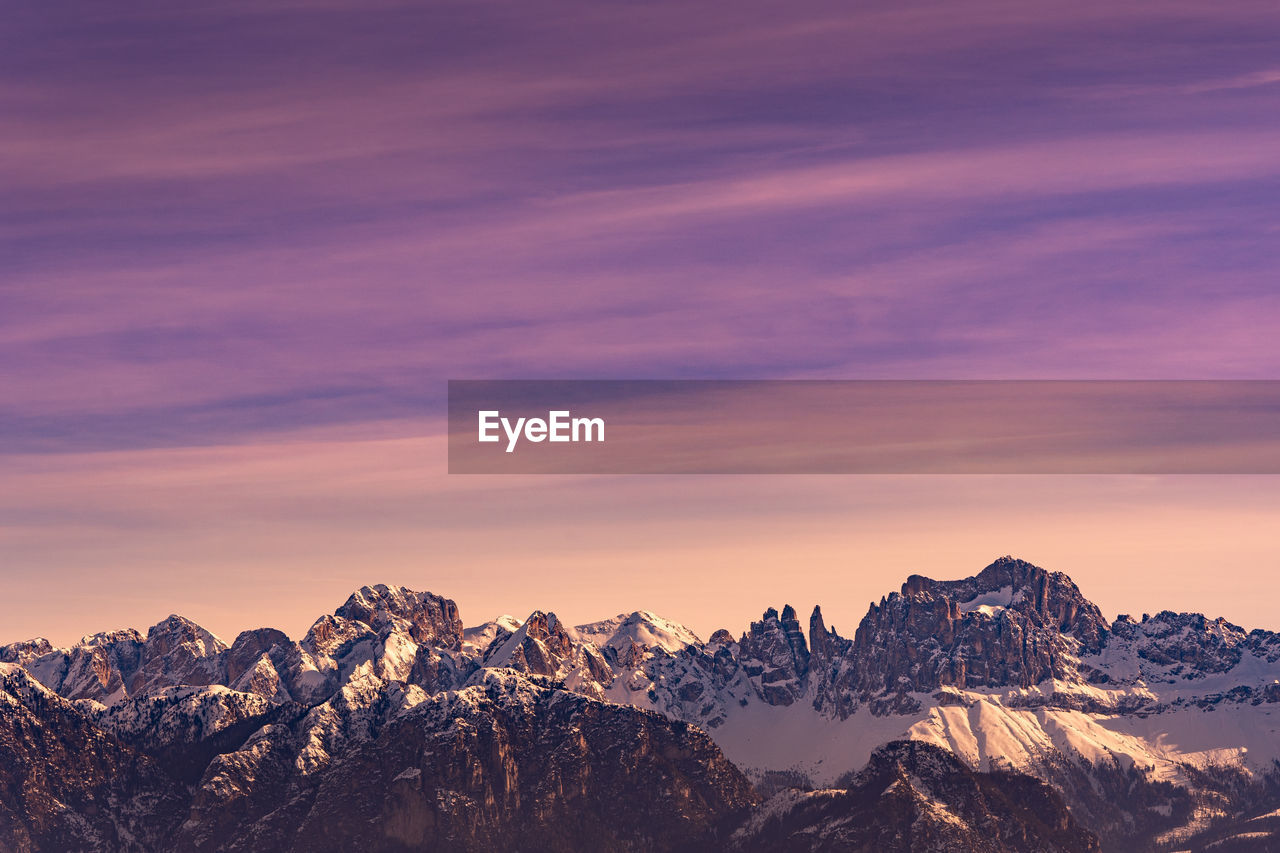 Scenic view of snowcapped mountains against sky during sunset