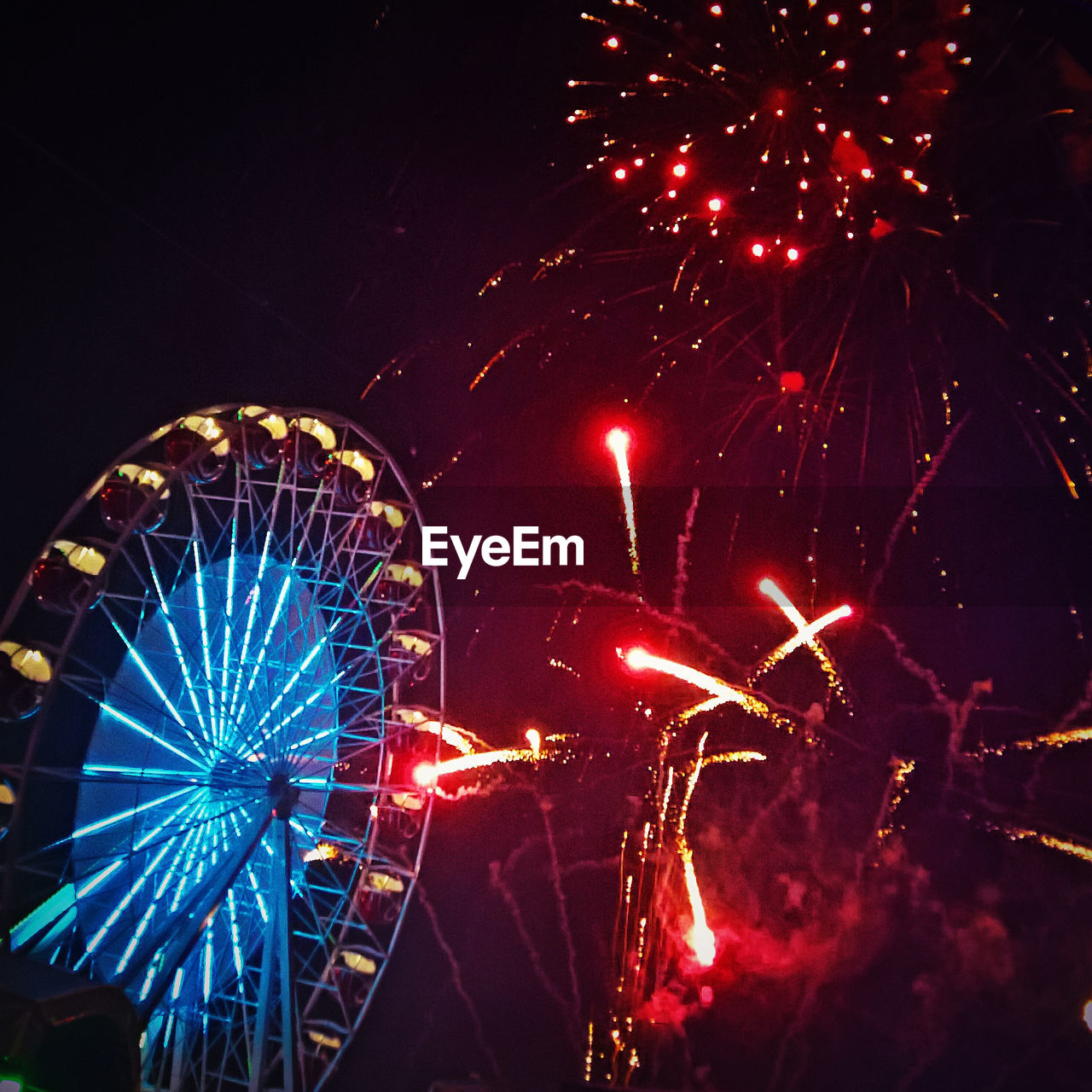 LOW ANGLE VIEW OF ILLUMINATED FIREWORKS