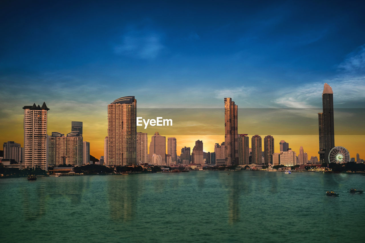 Bangkok's evening business city in thailand and the river is the center.